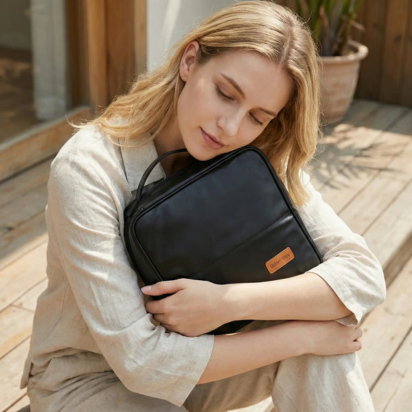A woman sat outside the door holding a sundaystatus makeup bag.