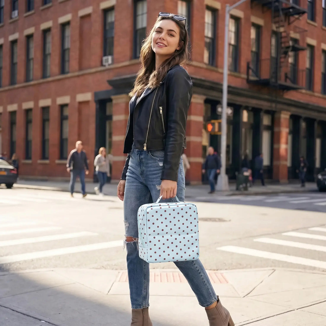 Traveler carrying a Sky Blue Artist Vanity makeup bag on a city street