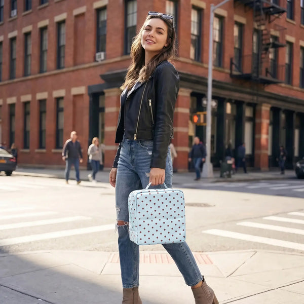 Traveler carrying a Sky Blue Artist Vanity makeup bag on a city street