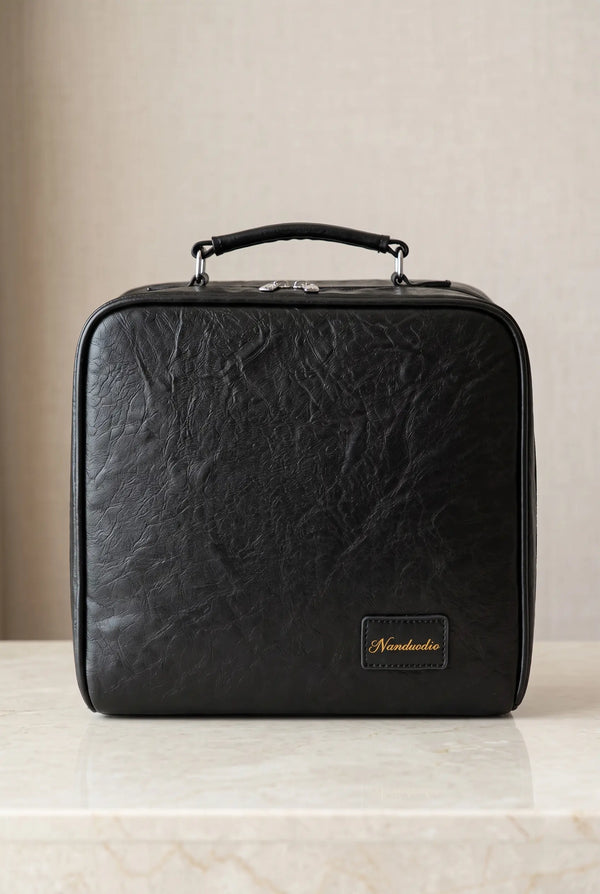Closed Midnight Black Grand Vanity stand-up makeup bag on a stone counter