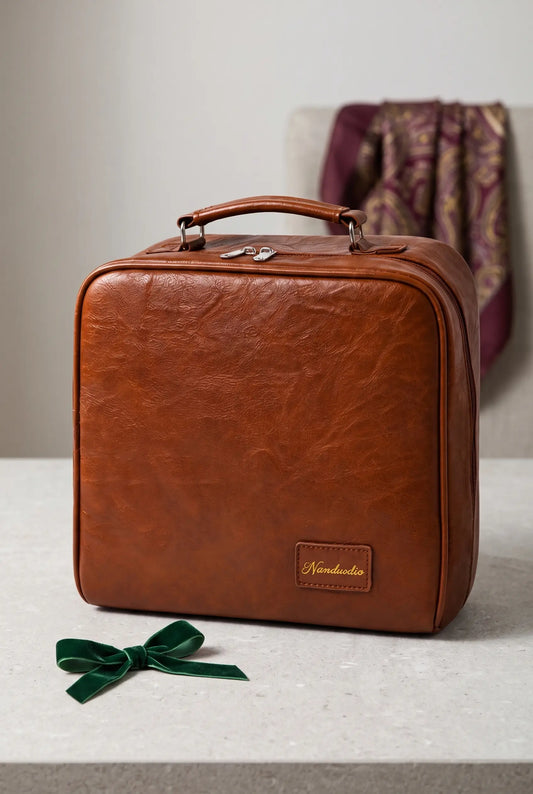 Closed Cocoa Grand Vanity presented with a green gift ribbon