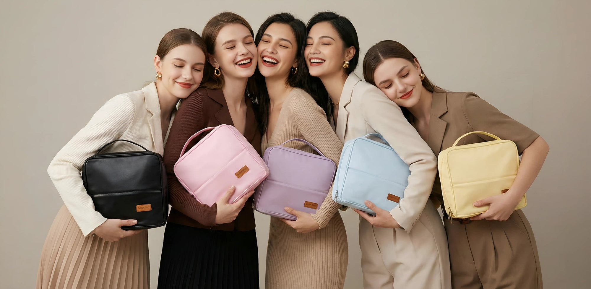 Five happy young women smiling and leaning close together, each embracing a Sunday Status stand-up travel makeup bag in various colors: black, pink, purple, light blue, and yellow. This cozy group shot highlights the bag as a perfect gift for friends