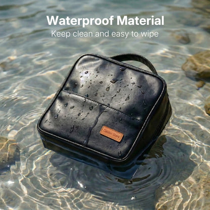 A black Sunday Status makeup bag partially submerged in water with visible droplets, demonstrating the premium waterproof material that is easy to wipe and keep clean