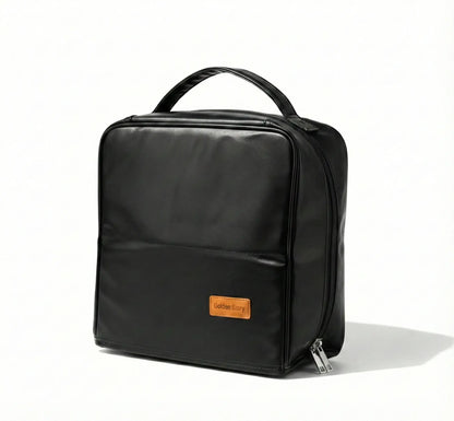 Front view of the black Sunday Status stand-up travel makeup bag on a clean white background, featuring a sturdy top handle, smooth zipper, and a minimalist design