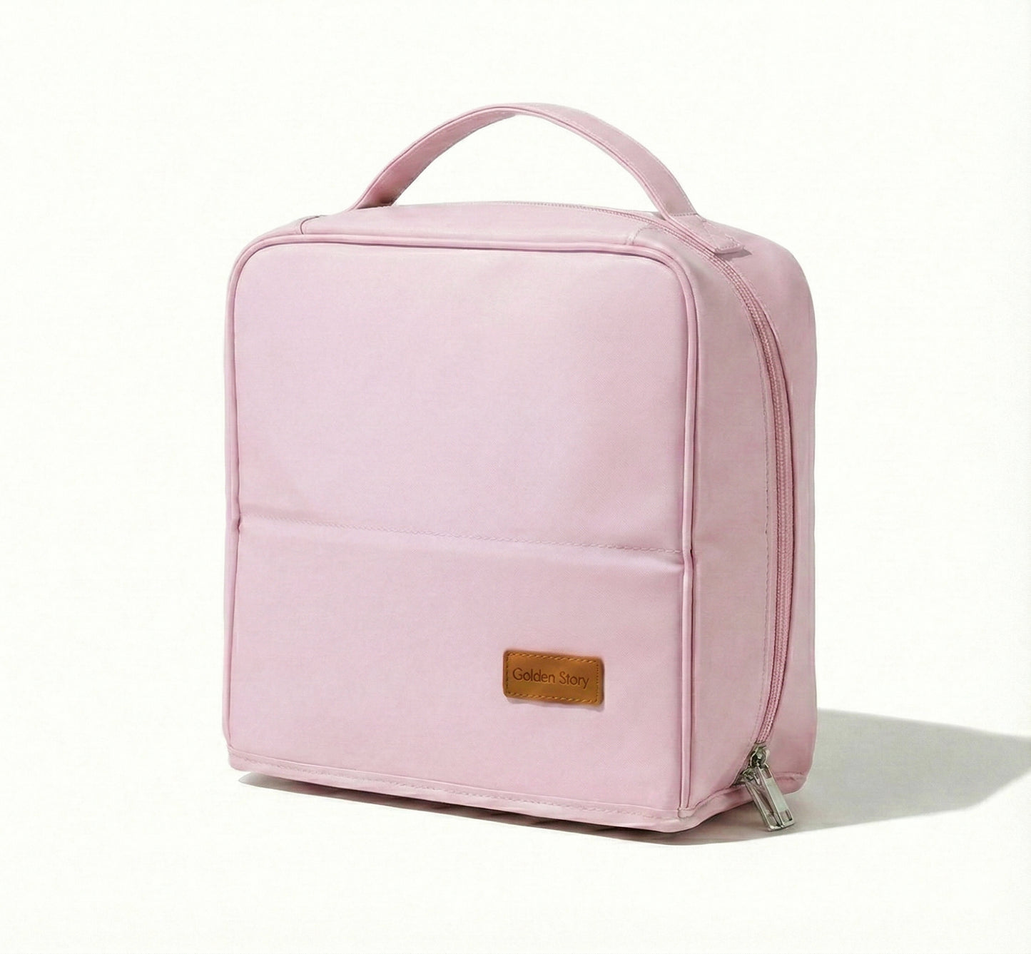 Front view of the pastel pink Sunday Status stand-up travel makeup bag on a clean white background, showcasing its structured square shape and convenient top handle