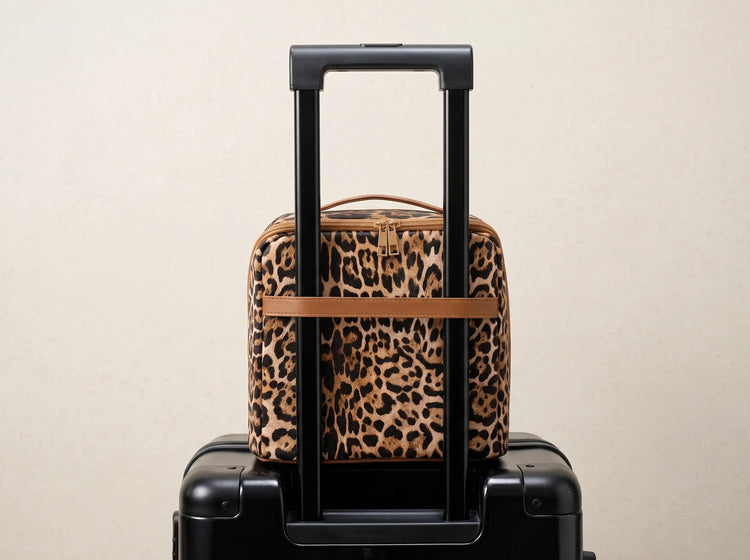 Wild Leopard Essential Vanity secured to rolling luggage with its trolley sleeve